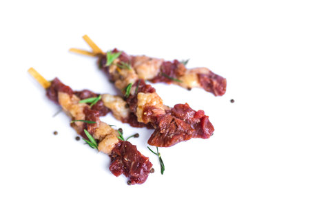 fresh raw beef meat with rosemary and pepper isolated on white. Food meat preparation cooking...