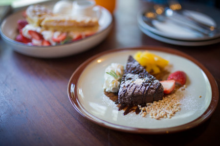 Picture of the homemade dark chocolate brownies and strawberry and fresh orrangeの写真素材