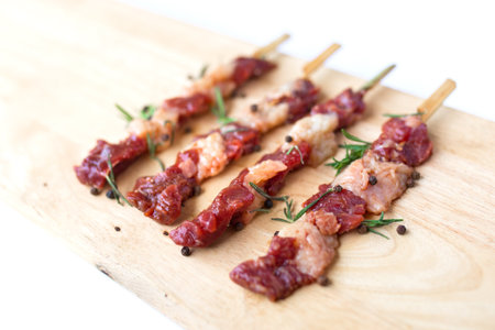 fresh raw beef meat with rosemary and pepper isolated on white. Food meat preparation cooking conceptの写真素材