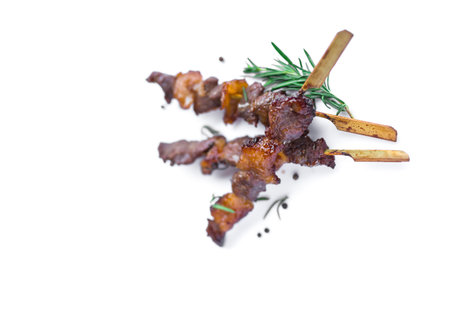 Grilled beef meat with rosemary and pepper isolated on white backgroundの写真素材