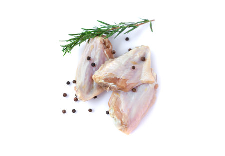 Raw chicken wings with garlic, pepperand rosemary isolated on white backgroundの写真素材