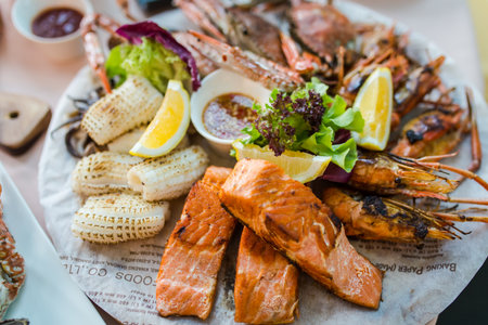 Picture of A delicious seafood at luxury restaurant. A plate of fresh seafood with shrimps, prawns, crabs, salmon, squid and musselsの写真素材