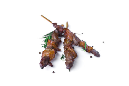 Grilled beef meat with rosemary and pepper isolated on white backgroundの写真素材