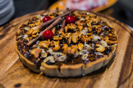 Picture of cashew nut and caramel syrup on chocolate tart cake