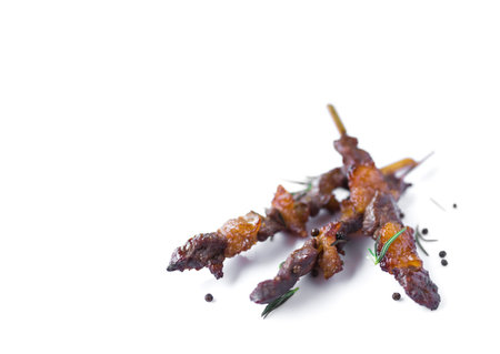 Grilled beef meat with rosemary and pepper isolated on white backgroundの写真素材