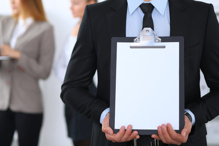 Unknown businessman holds clipboard with copy space areaの写真素材