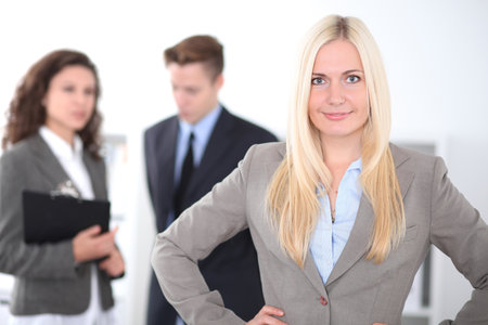 Face of beautiful cheerful smiling business woman on the background of business people Successful business conceptの写真素材