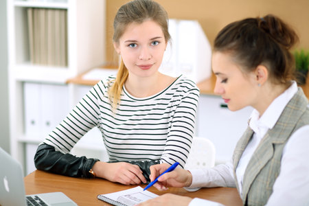 Young business woman designer discussing architecture project with client in office. Successful startup business concept.の写真素材
