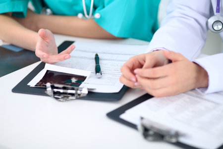Female doctor  and young surgeon intern in hospitalの写真素材
