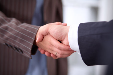 Business people shaking hands, standingの写真素材