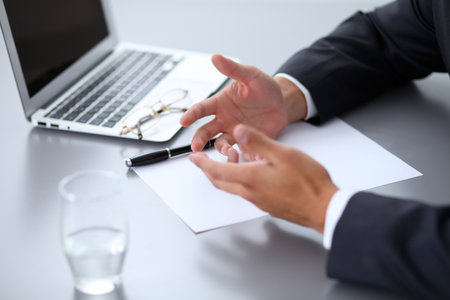Close-up of male hands with pen over document,  business conceptの写真素材
