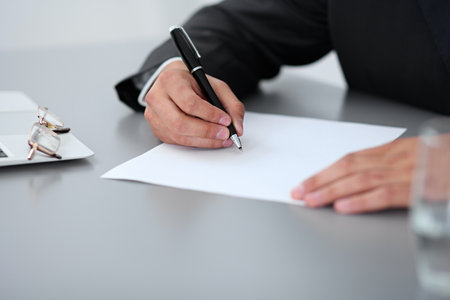 Close-up of male hands with pen over document,  business conceptの写真素材