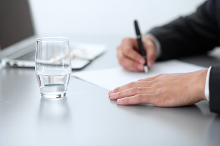 Close-up of male hands with pen over document,  business conceptの写真素材