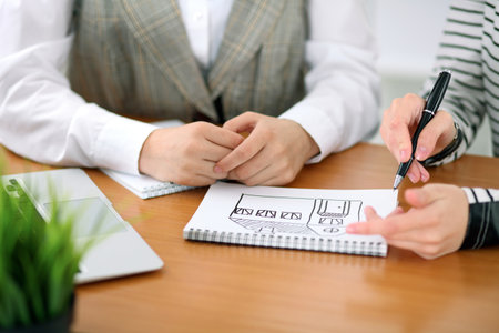 Young business woman designer discussing architecture project with client in office. Successful startup business concept.の写真素材