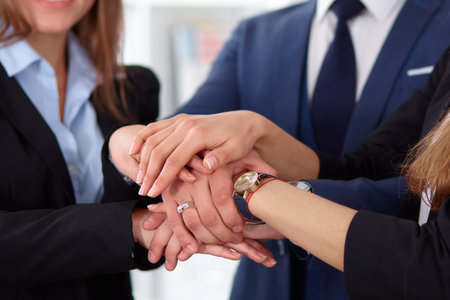 Business people group joining hands and representing concept of friendship and teamworkの写真素材