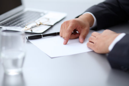 Close-up of male hands with pen over document,  business conceptの写真素材