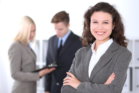 Face of beautiful cheerful smiling business woman on the background of business people Successful business conceptの写真素材