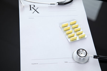 Stethoscope and prescription and pills, black reflective backgroundの写真素材