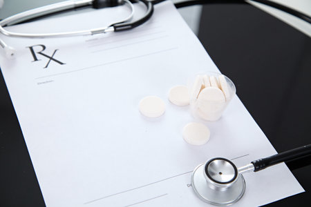 Stethoscope and prescription and pills, black reflective backgroundの写真素材