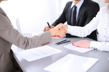 Business people shaking hands, finishing up a meeting. Copy space  at the left cornerの写真素材