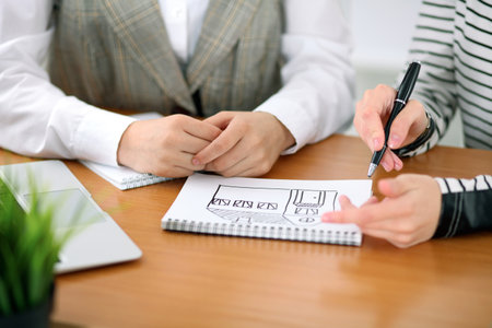 Young business woman designer discussing architecture project with client in office. Successful startup business concept.の写真素材
