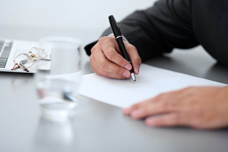Close-up of male hands with pen over document,  business conceptの写真素材