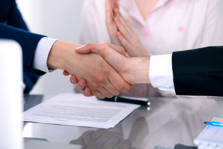 Business people shaking hands finishing up a meetingの写真素材
