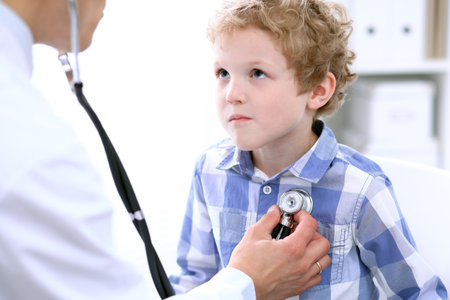 Doctor examining a child  patient by stethoscopeの写真素材