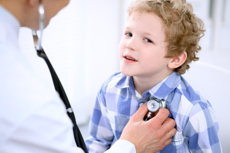 Doctor examining a child  patient by stethoscopeの写真素材