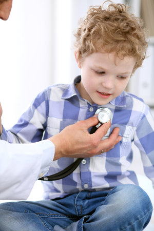 Doctor examining a child  patient by stethoscopeの写真素材