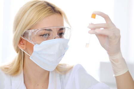 Female scientific research team with clear solution in laboratoryの写真素材