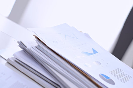 Office workplace with a laptop and financial documents