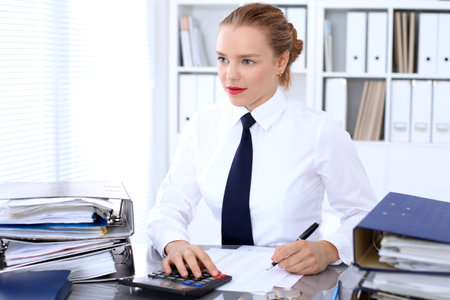 Business woman making report, calculating or checking balance.の写真素材
