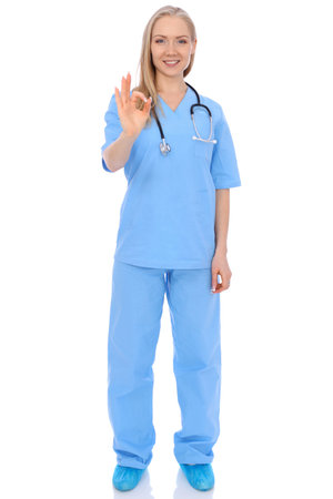 Smiling young nurse showing Ok sign isolated over white background. Advertising in medicine and health careの写真素材