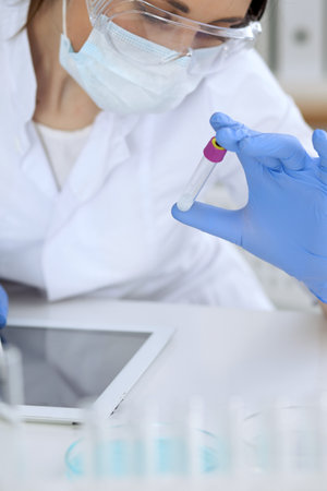 Close up of scientific research hands with clear solution in laboratoryの写真素材