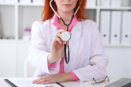 Doctor with a stethoscope in the hands. Pink colored sceneの写真素材