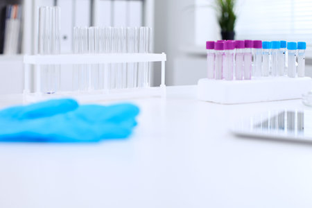 Research laboratory working space. Test tubes and tablet PC are lying at the table. Medical...