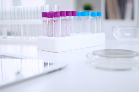 Research laboratory working space. Test tubes and tablet PC are lying at the table. Medical equipment. Blood testの写真素材