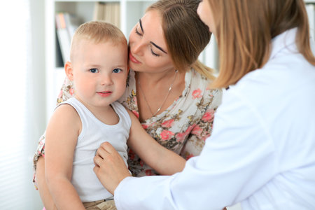 Doctor examining a child  patient by stethoscopeの写真素材