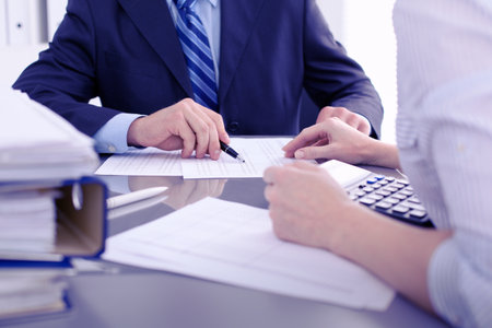 Bookkeepers or financial inspector making report, calculating or checking balance. Audit concept.の写真素材