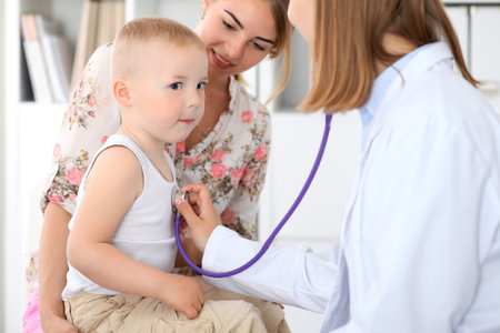 Doctor examining a child  patient by stethoscopeの写真素材
