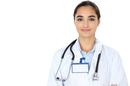 Cheerful smiling female doctor isolated over white background. Latin american or Hispanic young womanの写真素材