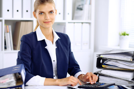 Modern business woman or confident female accountant in officeの写真素材