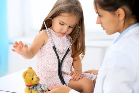 Happy little girl at  health exam at doctors officeの写真素材