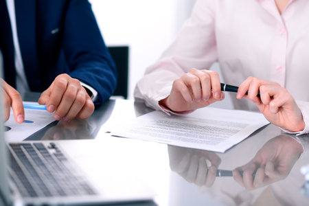 Group of business people and lawyers discussing contract papersの写真素材