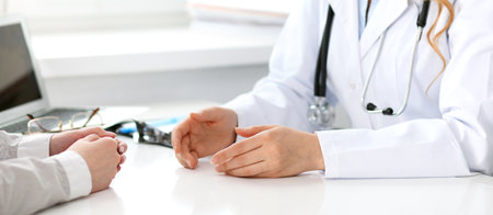 Doctor and patient sitting at the desk. Medicine and health care conceptの写真素材
