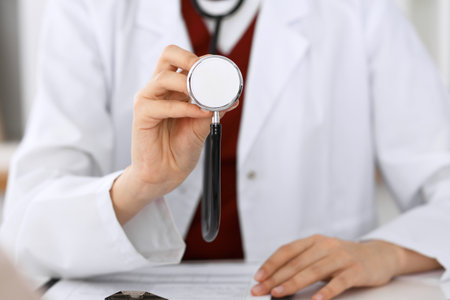 Unknown female doctor with a stethoscope in the hands. Physician is redy to exemine a patientの写真素材