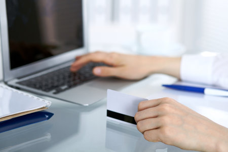 Close up of business woman hands typing on laptop computer.の写真素材