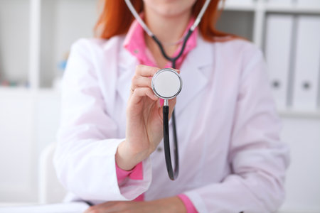 Doctor with a stethoscope in the hands. Pink colored sceneの写真素材