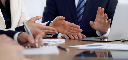 Group of business people or lawyers  at meeting, hands close-up.